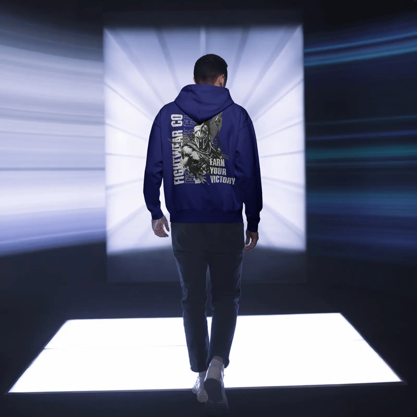 backview-hoodie-mockup-male-model-walking-towards-illuminated-white-square-platform-0768
