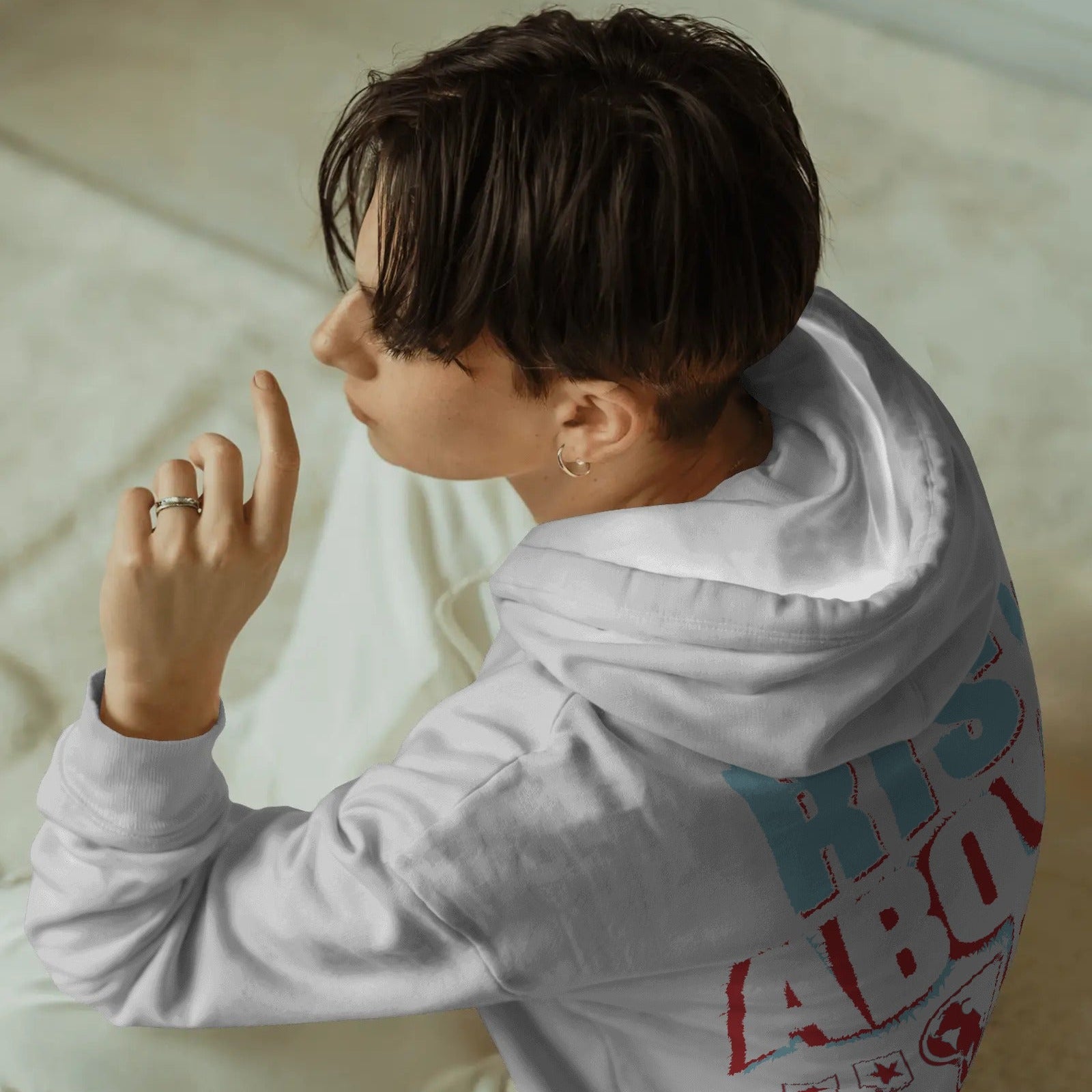 casual-indoor-white-hoodie-mockup-female-model-sitting-on-cream-carpeted-floor-in-soft-natural-light-modern-style-0702