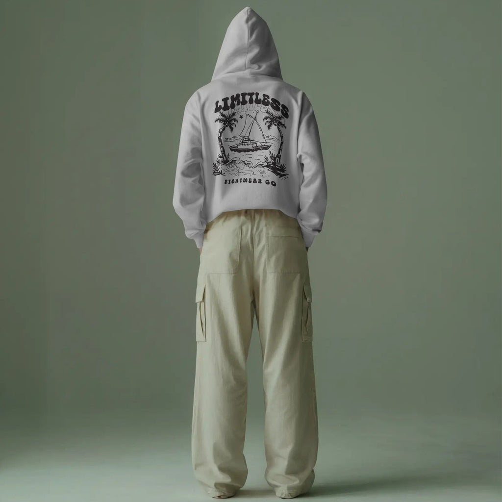 minimalist-studio-hoodie-mockup-back-view-male-model-wearing-beige-cargo-pants-against-muted-green-backdrop-0648