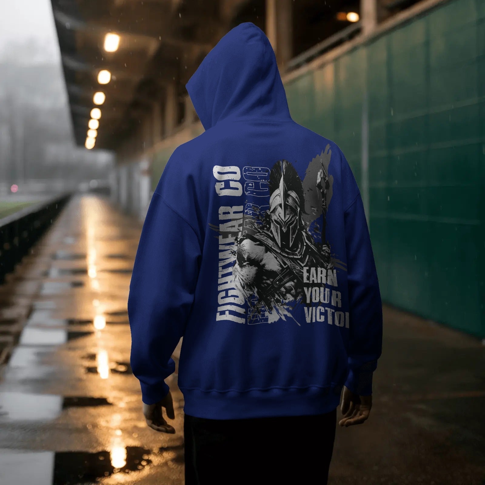 rainy-evening-hoodie-mockup-male-model-facing-away-under-covered-walkway-reflective-wet-surface-0788